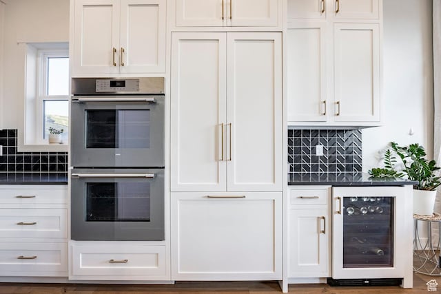 11795 N Star Gazer Cir, Hideout, UT 84036 - kitchen with stainless steel double oven, wine cooler, dark countertops, and tasteful backsplash