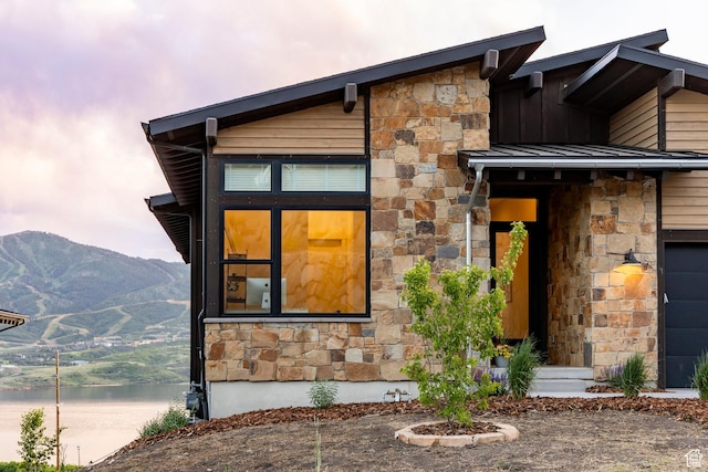 11795 N Star Gazer Cir, Hideout, UT 84036 - view of front of house with stone siding, board and batten siding, and a water and mountain view