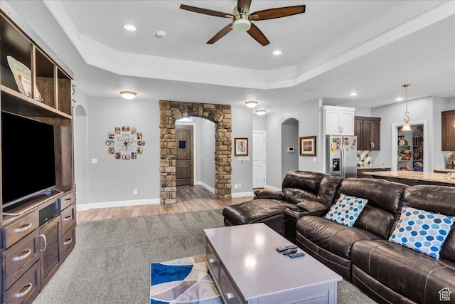 2644 E 3800 S, St George, UT 84790 - living room featuring arched walkways, ceiling fan, light wood finished floors, a raised ceiling, and recessed lighting