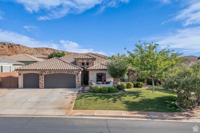 2644 E 3800 S, St George, UT 84790 - mediterranean / spanish-style house with a garage, a front yard, concrete driveway, stucco siding, and a tiled roof
