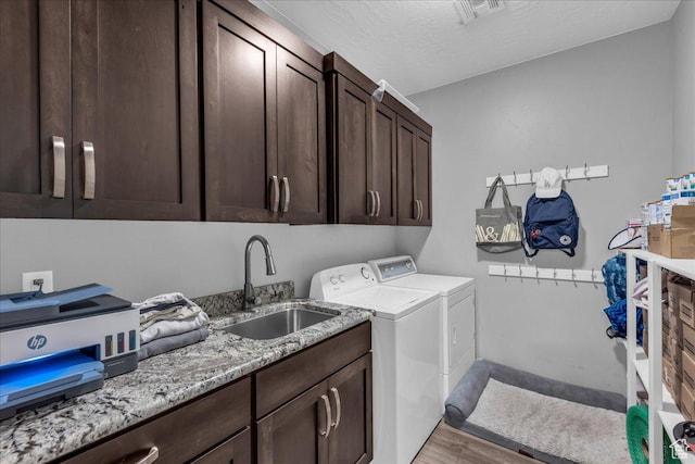 2644 E 3800 S, St George, UT 84790 - washroom featuring cabinet space, washer and dryer, and light wood-style flooring