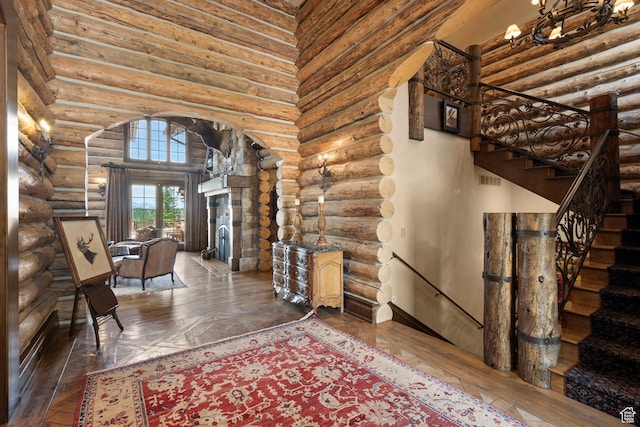 1943 N Wolf Creek Ranch Rd Unit 12, Heber City, UT 84032 - entrance foyer with arched walkways, rustic walls, wood-type flooring, and a towering ceiling