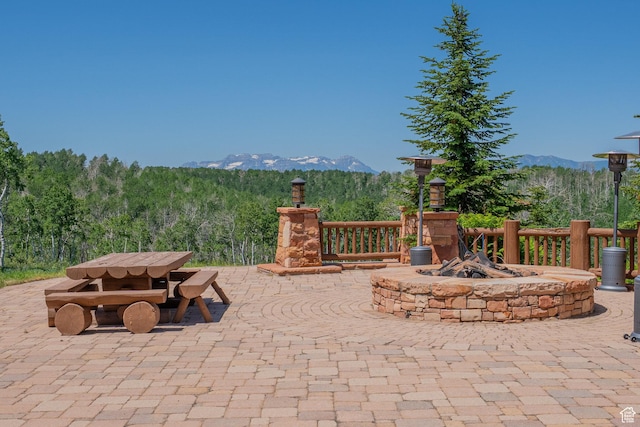 1943 N Wolf Creek Ranch Rd Unit 12, Heber City, UT 84032 - view of patio / terrace featuring a mountain view, a fire pit, a wooded view, and outdoor dining space