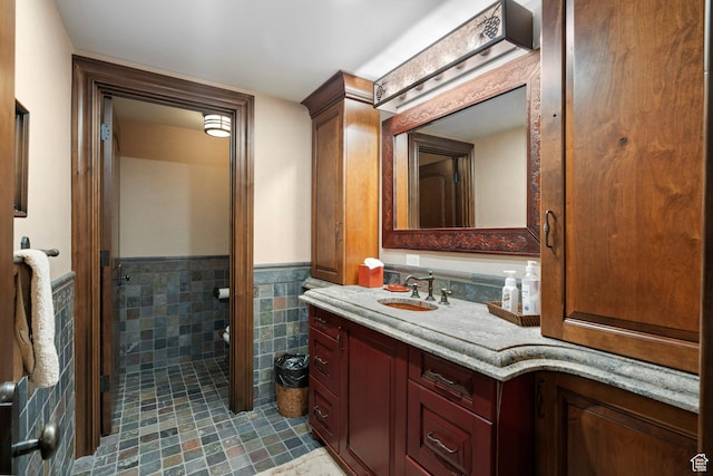 1943 N Wolf Creek Ranch Rd Unit 12, Heber City, UT 84032 - bathroom featuring vanity, a wainscoted wall, tile patterned flooring, and tile walls