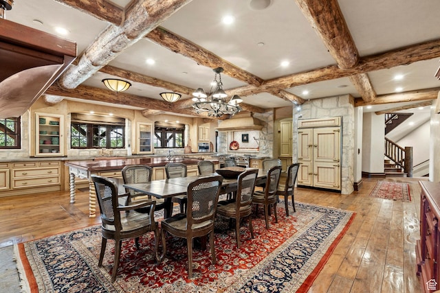 1943 N Wolf Creek Ranch Rd Unit 12, Heber City, UT 84032 - dining space featuring light wood finished floors, coffered ceiling, stairway, a chandelier, and beamed ceiling