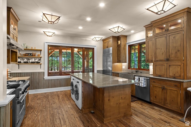 1943 N Wolf Creek Ranch Rd Unit 12, Heber City, UT 84032 - kitchen featuring premium appliances, ventilation hood, dark wood finished floors, a center island, and washer / dryer