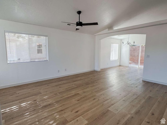 319 E 710 S, Ivins, UT 84738 - spare room with a ceiling fan, hardwood / wood-style flooring, a chandelier, vaulted ceiling, and arched walkways