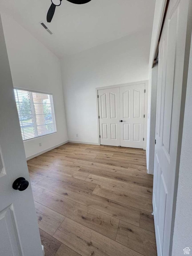 319 E 710 S, Ivins, UT 84738 - unfurnished bedroom featuring light wood-style flooring, vaulted ceiling, ceiling fan, and a closet