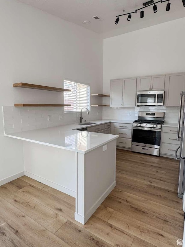 319 E 710 S, Ivins, UT 84738 - kitchen with stainless steel appliances, open shelves, gray cabinets, tasteful backsplash, and a peninsula