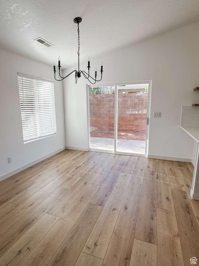 319 E 710 S, Ivins, UT 84738 - unfurnished dining area with a chandelier and light wood-type flooring