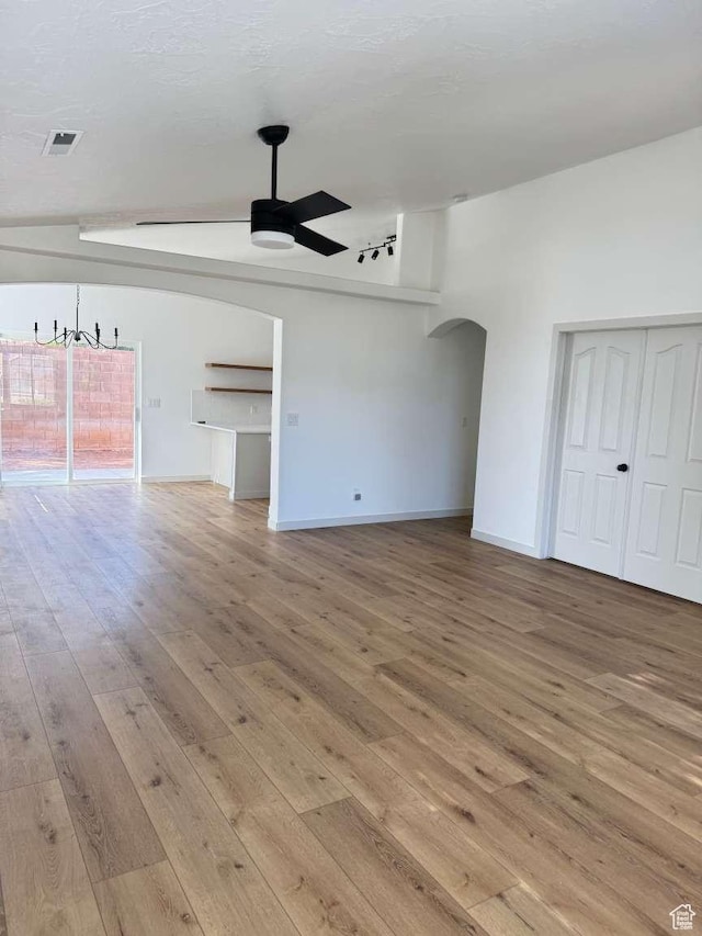 319 E 710 S, Ivins, UT 84738 - unfurnished living room featuring ceiling fan, arched walkways, and hardwood / wood-style floors