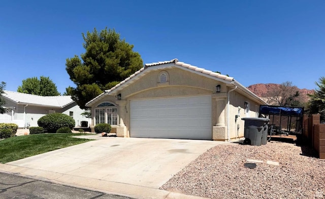 319 E 710 S, Ivins, UT 84738 - ranch-style house with driveway, an attached garage, and stucco siding