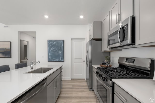 1813 E Bison Dr N Unit B213, Eagle Mountain, UT 84005 - kitchen featuring appliances with stainless steel finishes, gray cabinetry, light countertops, light wood-style flooring, and recessed lighting