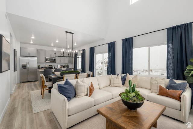 1813 E Bison Dr N Unit B213, Eagle Mountain, UT 84005 - living room with light wood-style floors, recessed lighting, and a chandelier