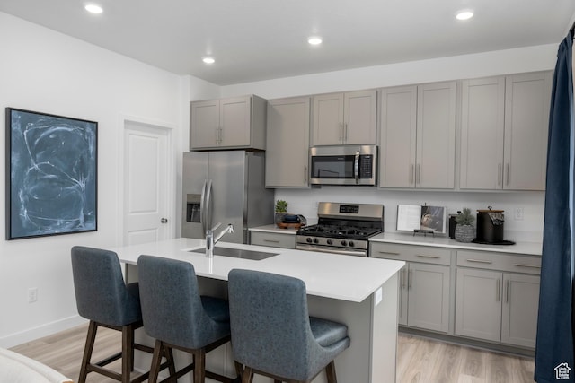 1813 E Bison Dr N Unit B213, Eagle Mountain, UT 84005 - kitchen with appliances with stainless steel finishes, gray cabinets, light wood-style flooring, light countertops, and recessed lighting