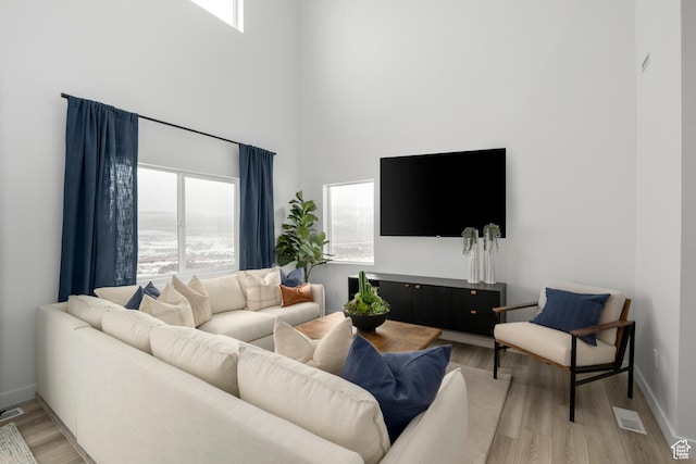 1813 E Bison Dr N Unit B213, Eagle Mountain, UT 84005 - living room featuring a high ceiling and light wood-style flooring