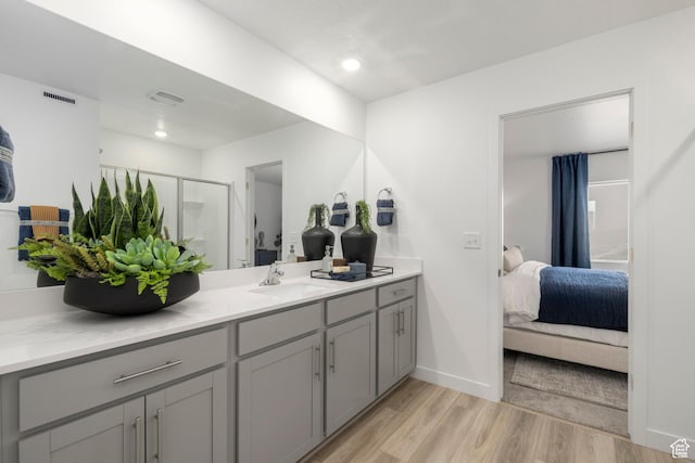 1813 E Bison Dr N Unit B213, Eagle Mountain, UT 84005 - ensuite bathroom with vanity, wood finished floors, a shower stall, and recessed lighting