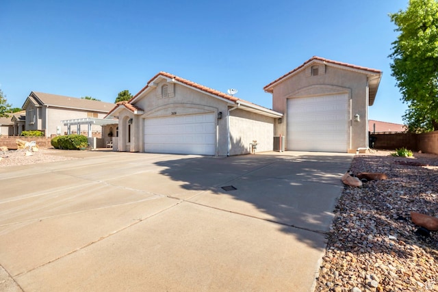 3430 Red Butte Dr, Santa Clara, UT 84765 - mediterranean / spanish-style home with concrete driveway, stucco siding, a tile roof, and an attached garage