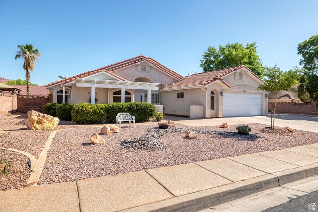 3430 Red Butte Dr, Santa Clara, UT 84765 - view of front of house featuring a tile roof, driveway, stucco siding, an attached garage, and a pergola