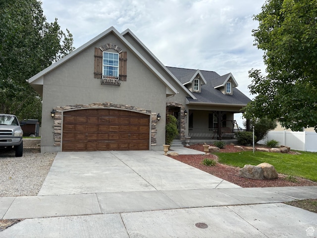 332 W Hillside S, Saratoga Springs, UT 84045 - view of front of property with covered porch, concrete driveway, stone siding, stucco siding, and an attached garage