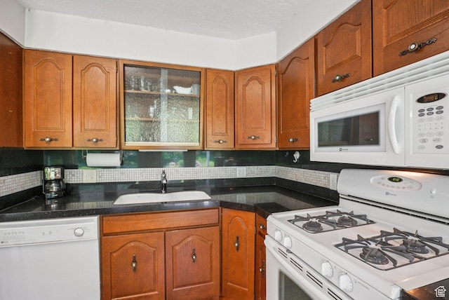 4199 S Monarch Way, Salt Lake City, UT 84124 - kitchen featuring white appliances, brown cabinets, and tasteful backsplash