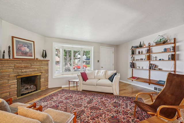 4199 S Monarch Way, Salt Lake City, UT 84124 - living room with wood finished floors, a stone fireplace, and a textured ceiling