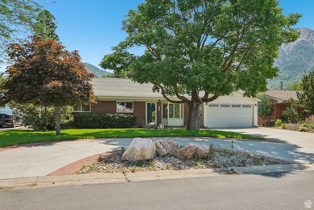 4199 S Monarch Way, Salt Lake City, UT 84124 - view of front of property with a mountain view, driveway, brick siding, a front lawn, and a garage
