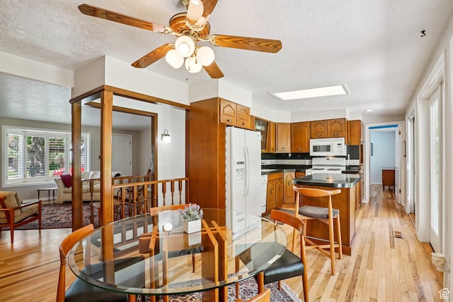 4199 S Monarch Way, Salt Lake City, UT 84124 - dining space with light wood-style flooring, a textured ceiling, and a ceiling fan