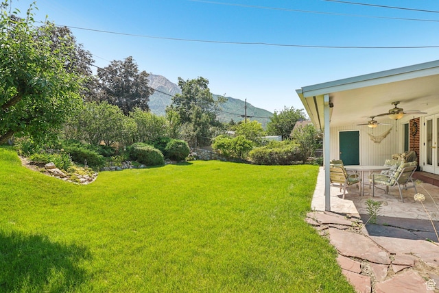 4199 S Monarch Way, Salt Lake City, UT 84124 - view of grassy yard with a ceiling fan, a patio, and a mountain view