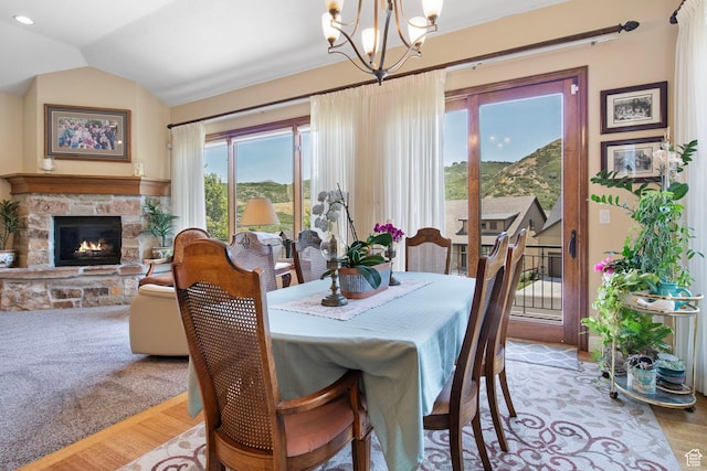 14599 S Chaumont Ct, Draper, UT 84020 - dining space with a chandelier, a stone fireplace, light wood-style floors, vaulted ceiling, and a mountain view