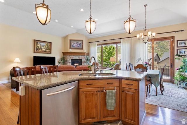 14599 S Chaumont Ct, Draper, UT 84020 - kitchen with dishwasher, light wood-style flooring, a fireplace, open floor plan, and lofted ceiling