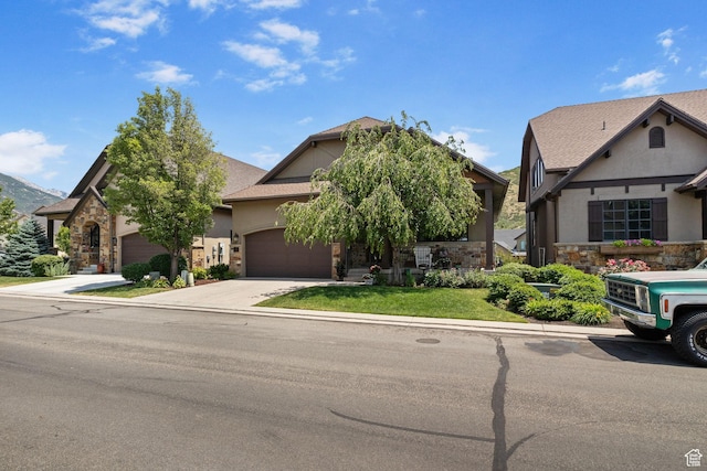 14599 S Chaumont Ct, Draper, UT 84020 - view of front facade featuring stone siding, an attached garage, concrete driveway, and stucco siding