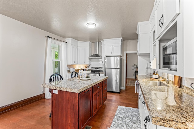 727 S Main St, Mapleton, UT 84664 - kitchen with stainless steel appliances, wall chimney range hood, a textured ceiling, dark wood-style flooring, and white cabinetry