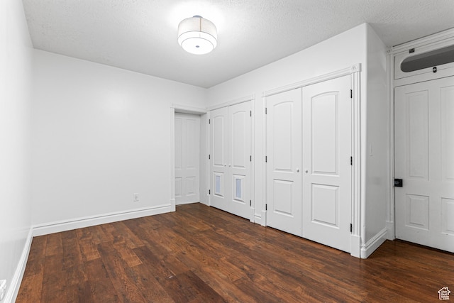 727 S Main St, Mapleton, UT 84664 - unfurnished bedroom with multiple closets, dark wood-style floors, and a textured ceiling