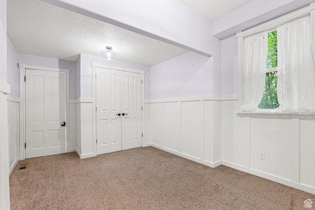 727 S Main St, Mapleton, UT 84664 - unfurnished bedroom featuring wainscoting, carpet, a textured ceiling, a closet, and a decorative wall