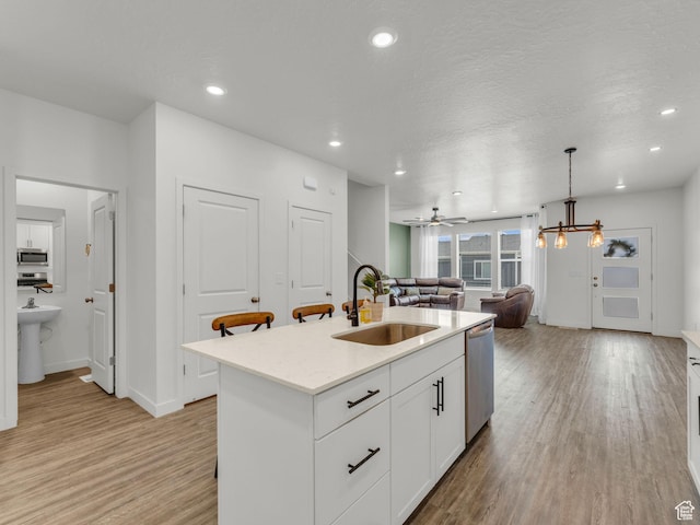 937 W Purpledisk Ct, Saratoga Springs, UT 84045 - kitchen with appliances with stainless steel finishes, light wood finished floors, open floor plan, white cabinetry, and recessed lighting
