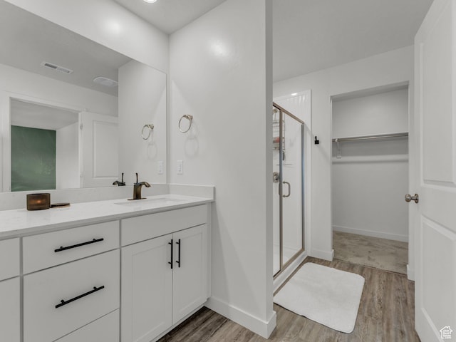 937 W Purpledisk Ct, Saratoga Springs, UT 84045 - full bathroom with wood finished floors, vanity, a shower stall, and a spacious closet