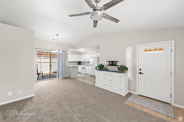 1360 E Telegraph St Unit 18, Washington, UT 84780 - living area with vaulted ceiling, light colored carpet, a ceiling fan, and a chandelier
