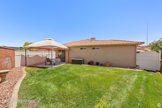 1360 E Telegraph St Unit 18, Washington, UT 84780 - rear view of property featuring stucco siding, a tiled roof, a fenced backyard, and a patio