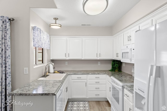 1360 E Telegraph St Unit 18, Washington, UT 84780 - kitchen with white appliances, white cabinetry, and light wood-style floors
