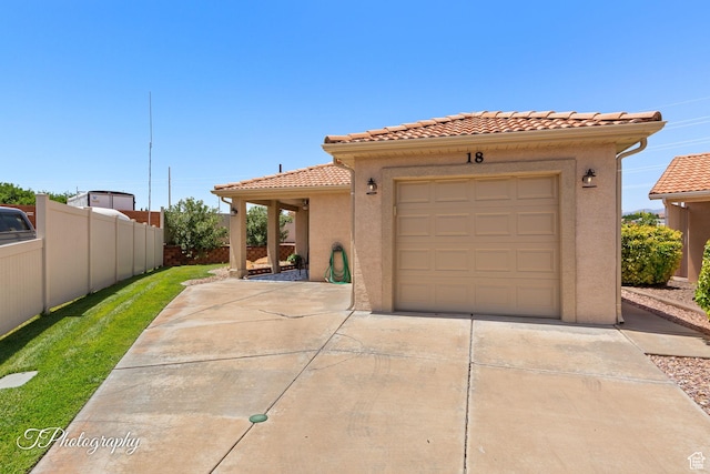 1360 E Telegraph St Unit 18, Washington, UT 84780 - view of front of property with driveway, a tile roof, and stucco siding