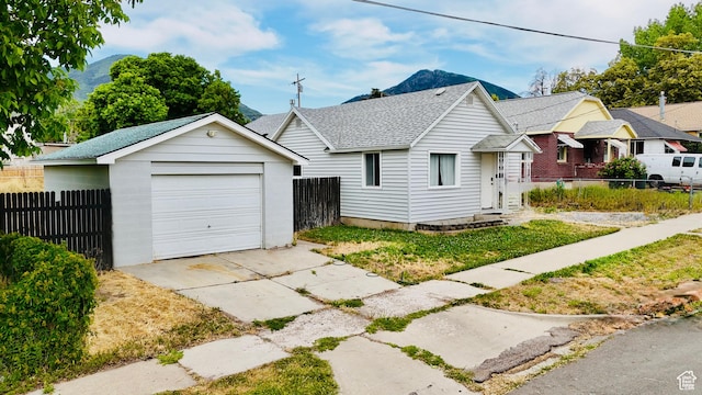 78 N N 3rd St N, Tooele, UT 84074 - view of front of property featuring driveway, a detached garage, an outdoor structure, and roof with shingles