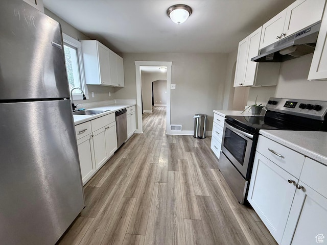 78 N N 3rd St N, Tooele, UT 84074 - kitchen featuring stainless steel appliances, under cabinet range hood, light countertops, and white cabinetry