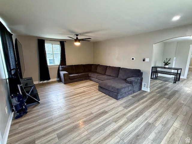 78 N N 3rd St N, Tooele, UT 84074 - living room with arched walkways, ceiling fan, and light wood-style flooring