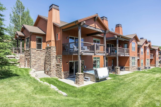 1161 W Wintercress Trl W Unit 27F, Kamas, UT 84036 - back of house featuring a chimney, board and batten siding, a patio area, and a yard