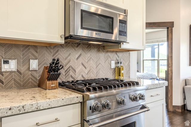 1161 W Wintercress Trl W Unit 27F, Kamas, UT 84036 - kitchen featuring stainless steel appliances, light stone countertops, white cabinetry, backsplash, and dark wood-style flooring