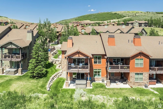 1161 W Wintercress Trl W Unit 27F, Kamas, UT 84036 - back of property with stone siding, a residential view, and a patio area