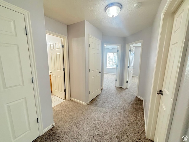 10521 S Sage Flats Way S, Jordan, UT 84009 - hallway with light colored carpet and a textured ceiling