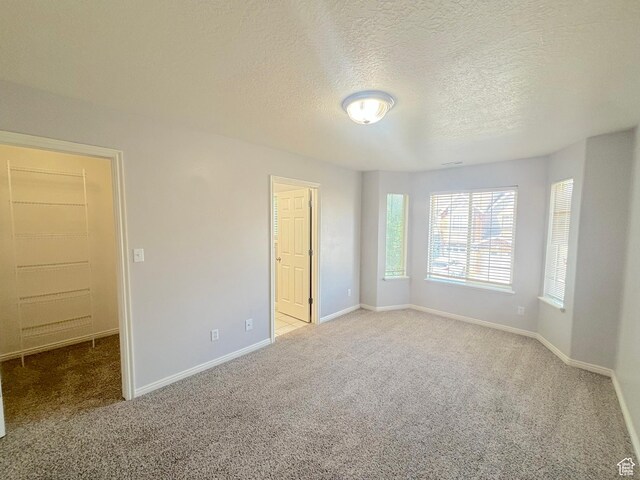 10521 S Sage Flats Way S, Jordan, UT 84009 - empty room featuring carpet and a textured ceiling