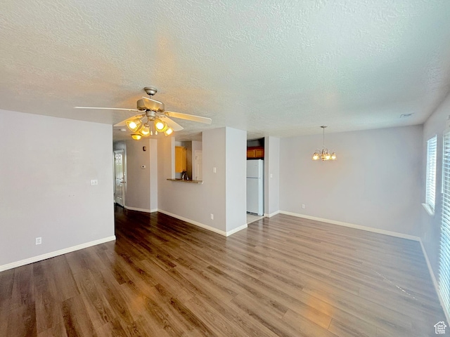 10521 S Sage Flats Way S, Jordan, UT 84009 - unfurnished living room with a chandelier, a textured ceiling, wood finished floors, and a ceiling fan